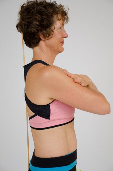 Margaret aligning her back to a ruler